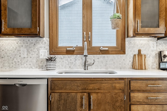912 Delray Dr, Indianapolis, IN 46241 - kitchen with dishwasher, a sink, glass insert cabinets, backsplash, and light countertops