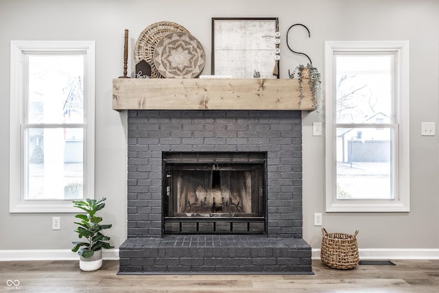 912 Delray Dr, Indianapolis, IN 46241 - detailed view of a fireplace, wood finished floors, and baseboards