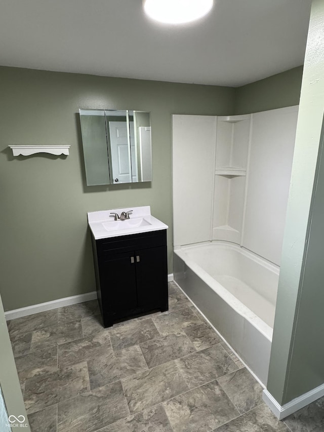 707 N Water St, Hillsboro, IN 47949 - bathroom featuring baseboards, vanity, stone finish flooring, and shower / bathtub combination