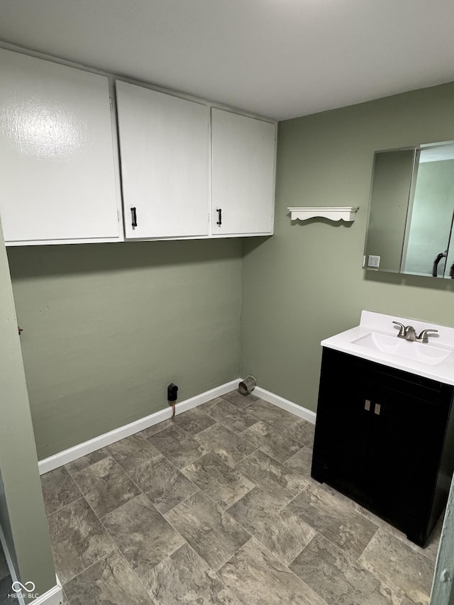 707 N Water St, Hillsboro, IN 47949 - laundry area with cabinet space, baseboards, and stone finish floors