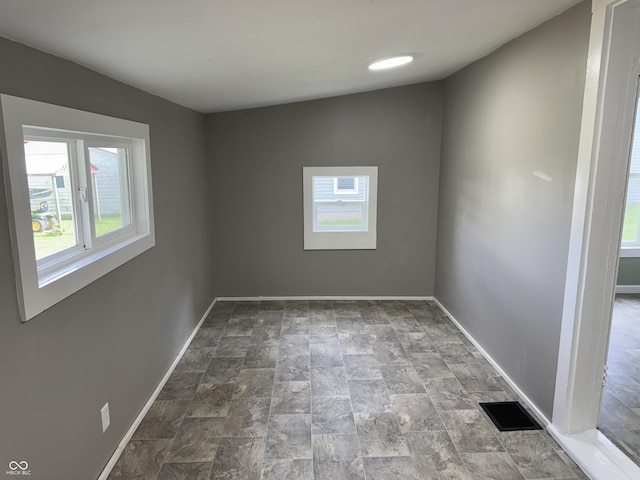 707 N Water St, Hillsboro, IN 47949 - spare room with healthy amount of natural light, baseboards, and stone finish flooring