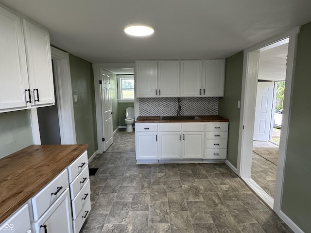 707 N Water St, Hillsboro, IN 47949 - kitchen featuring butcher block counters, white cabinets, and baseboards