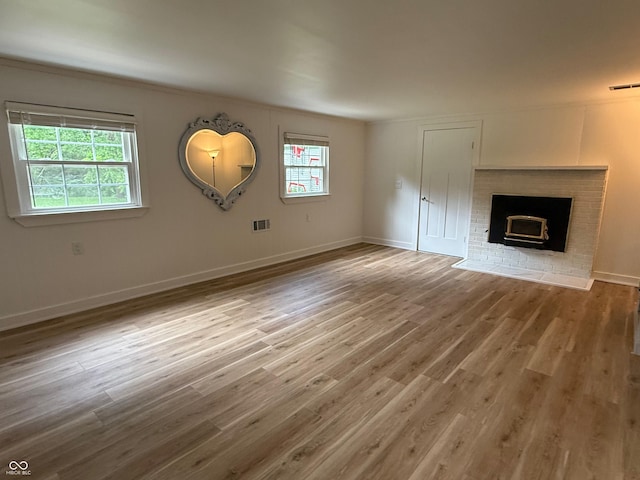 2346 N State Road 39, Danville, IN 46122 - unfurnished living room featuring plenty of natural light, wood finished floors, crown molding, and a fireplace