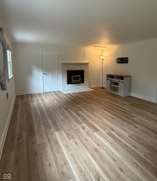 2346 N State Road 39, Danville, IN 46122 - unfurnished living room featuring a brick fireplace and wood finished floors