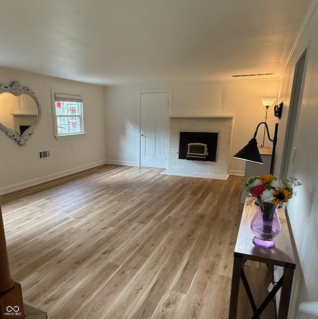 2346 N State Road 39, Danville, IN 46122 - unfurnished living room with light wood-type flooring and a brick fireplace
