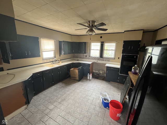 16 S 7th St, West Terre Haute, IN 47885 - kitchen featuring black oven, a sink, a ceiling fan, and light countertops