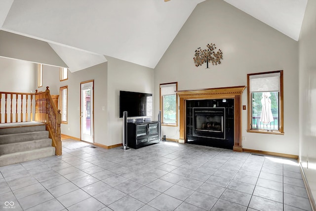 1344 S Fox Paw Dr, New Palestine, IN 46163 - unfurnished living room featuring high vaulted ceiling, light tile patterned flooring, stairway, and a fireplace
