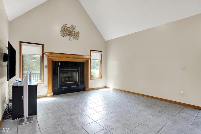 1344 S Fox Paw Dr, New Palestine, IN 46163 - unfurnished living room featuring high vaulted ceiling, light tile patterned floors, and a fireplace