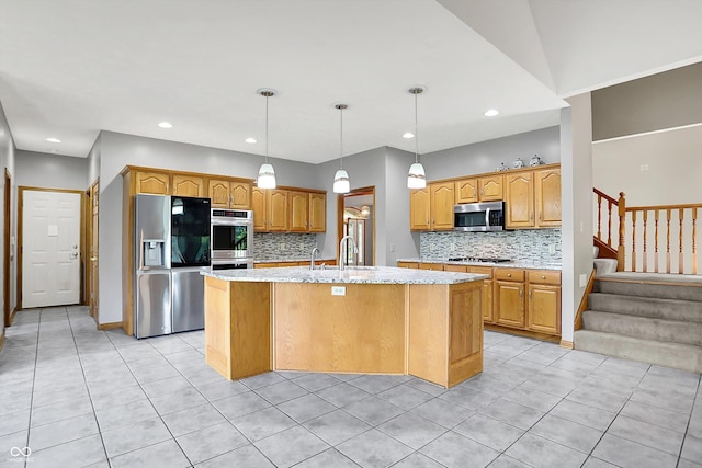 1344 S Fox Paw Dr, New Palestine, IN 46163 - kitchen featuring appliances with stainless steel finishes, light tile patterned floors, tasteful backsplash, a center island with sink, and recessed lighting