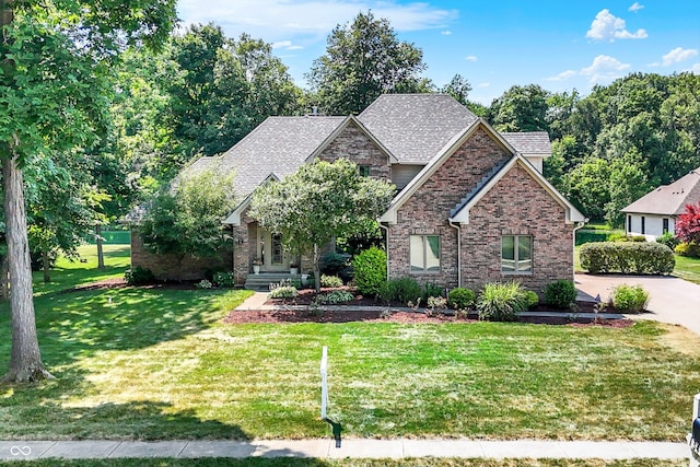 1344 S Fox Paw Dr, New Palestine, IN 46163 - craftsman house with a front yard, brick siding, roof with shingles, and concrete driveway