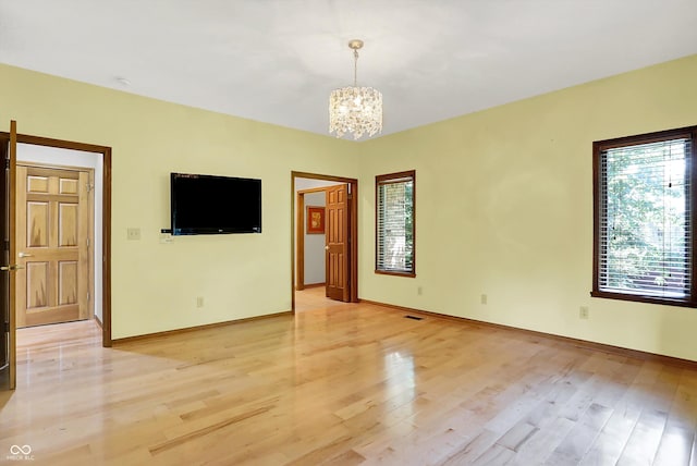 1344 S Fox Paw Dr, New Palestine, IN 46163 - unfurnished room featuring a chandelier and light wood-style floors