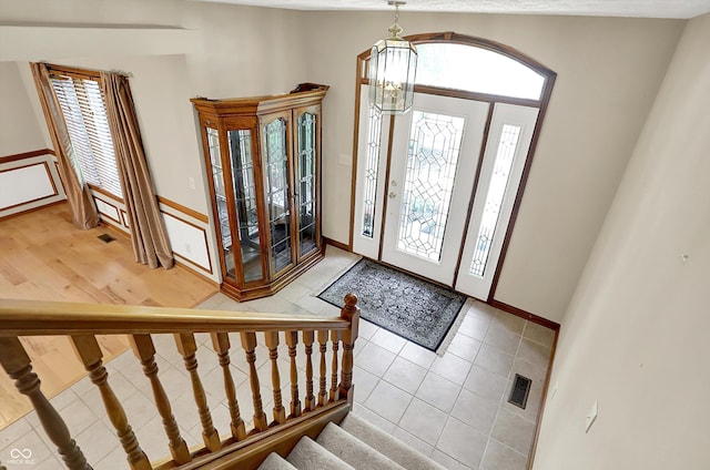 1344 S Fox Paw Dr, New Palestine, IN 46163 - foyer entrance with plenty of natural light, a chandelier, light tile patterned floors, and stairway