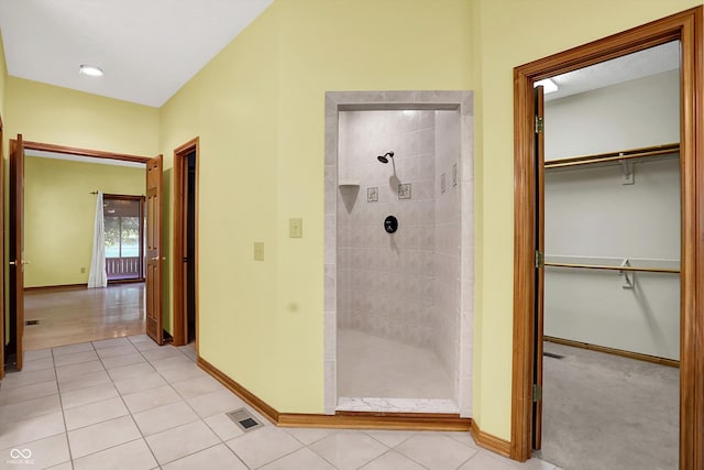 1344 S Fox Paw Dr, New Palestine, IN 46163 - full bath featuring tiled shower, tile patterned floors, and a walk in closet