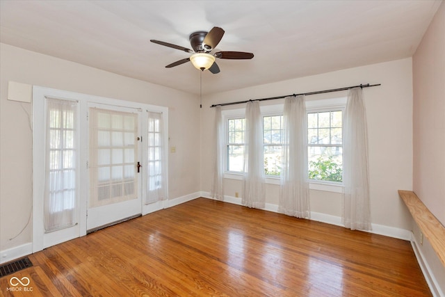 1015 Fairfield Ave, Indianapolis, IN 46205 - empty room with wood finished floors, ceiling fan, and baseboards