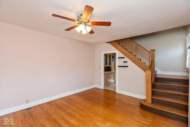 1015 Fairfield Ave, Indianapolis, IN 46205 - unfurnished living room with stairway, wood finished floors, ceiling fan, and baseboards