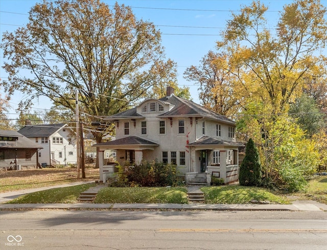 1015 Fairfield Ave, Indianapolis, IN 46205 - view of front of home featuring stucco siding, a chimney, and a front lawn