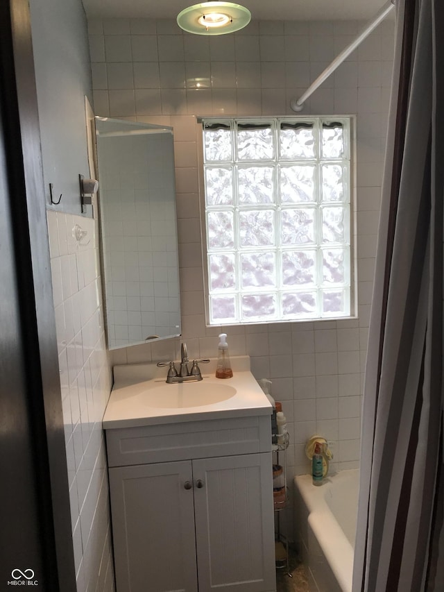1015 Fairfield Ave, Indianapolis, IN 46205 - bathroom featuring tile walls, vanity, shower / bath combo, and tasteful backsplash