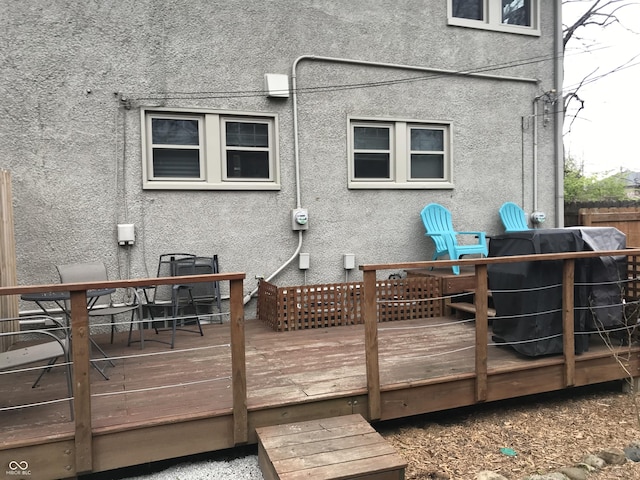 1015 Fairfield Ave, Indianapolis, IN 46205 - rear view of house featuring stucco siding, a deck, and outdoor dining space