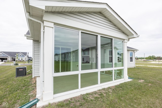 1863 River Birch Dr, Greenfield, IN 46140 - view of home's exterior with central AC unit, a sunroom, and a lawn