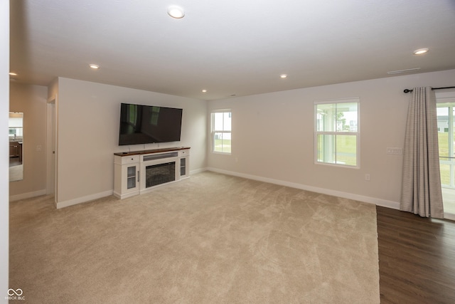 1863 River Birch Dr, Greenfield, IN 46140 - unfurnished living room featuring baseboards, recessed lighting, a fireplace, and carpet flooring