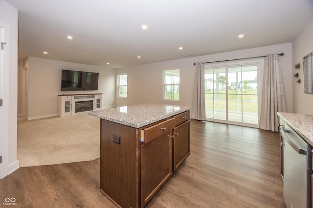 1863 River Birch Dr, Greenfield, IN 46140 - kitchen featuring stainless steel dishwasher, open floor plan, recessed lighting, light stone counters, and a fireplace