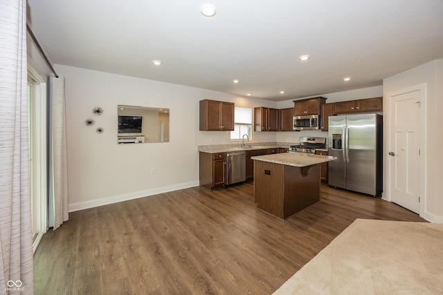 1863 River Birch Dr, Greenfield, IN 46140 - kitchen featuring appliances with stainless steel finishes, a kitchen island, dark wood finished floors, a sink, and baseboards