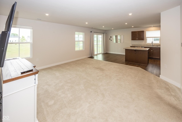 1863 River Birch Dr, Greenfield, IN 46140 - unfurnished living room with dark colored carpet, healthy amount of natural light, recessed lighting, and baseboards