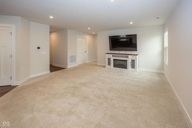 1863 River Birch Dr, Greenfield, IN 46140 - unfurnished living room with recessed lighting, baseboards, and carpet floors