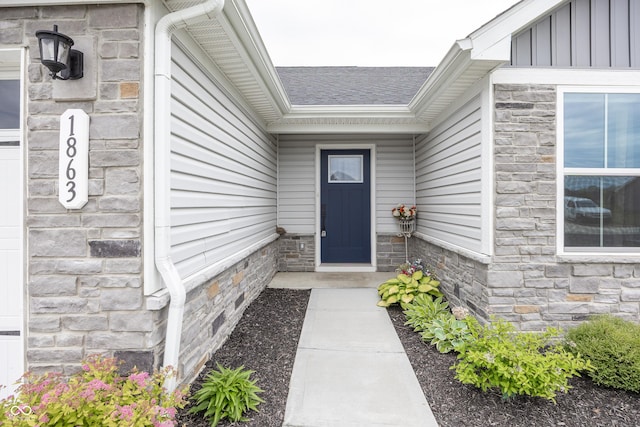 1863 River Birch Dr, Greenfield, IN 46140 - view of exterior entry featuring stone siding, a shingled roof, and board and batten siding