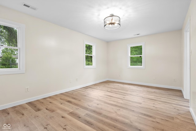 5422 Orange St, Indianapolis, IN 46203 - empty room featuring healthy amount of natural light, a chandelier, light wood-type flooring, and baseboards