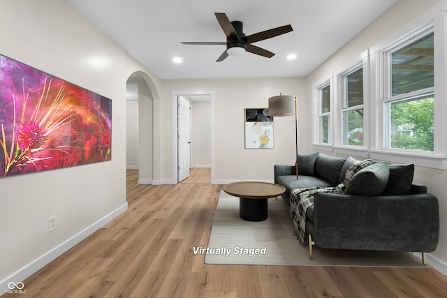 5422 Orange St, Indianapolis, IN 46203 - living room featuring arched walkways, baseboards, wood finished floors, ceiling fan, and recessed lighting