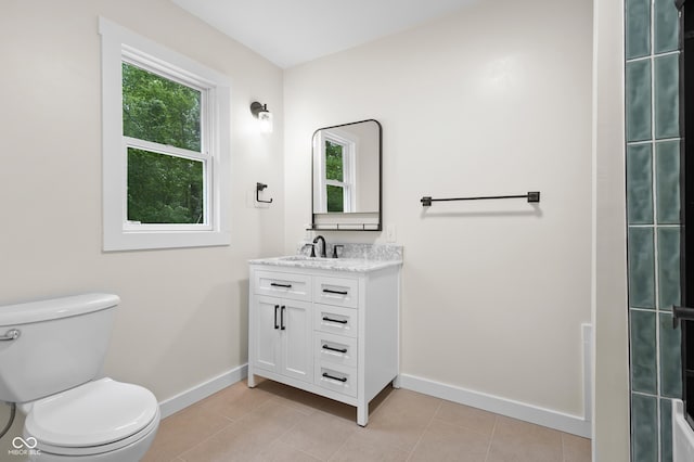 5422 Orange St, Indianapolis, IN 46203 - bathroom with baseboards, toilet, vanity, and tile patterned floors