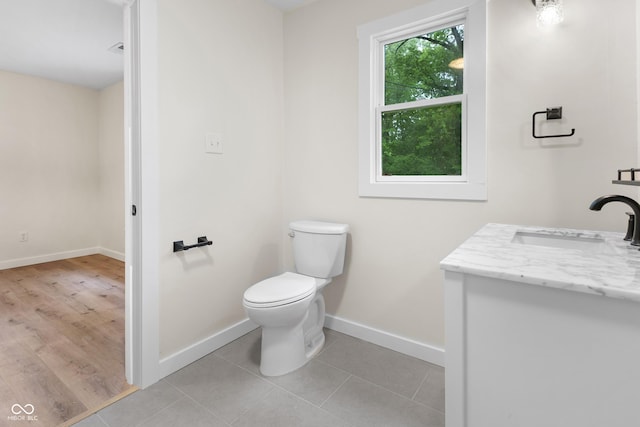 5422 Orange St, Indianapolis, IN 46203 - bathroom with vanity, toilet, baseboards, and tile patterned flooring