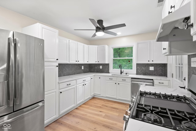 5422 Orange St, Indianapolis, IN 46203 - kitchen with stainless steel appliances, a sink, a ceiling fan, and white cabinets
