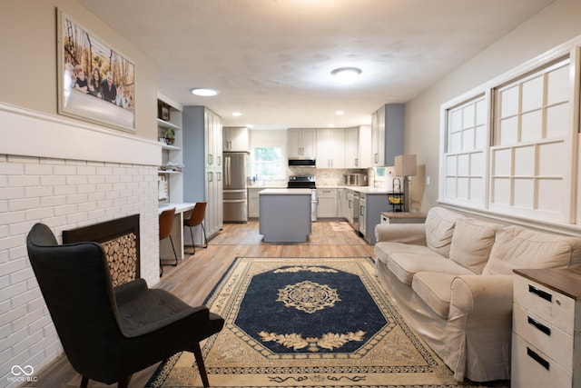 6799 Lakeshore Dr, Avon, IN 46123 - living area with light wood finished floors, a fireplace, and recessed lighting
