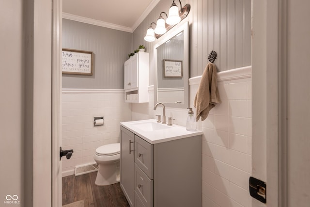 6799 Lakeshore Dr, Avon, IN 46123 - bathroom featuring tile walls, toilet, vanity, wood finished floors, and ornamental molding