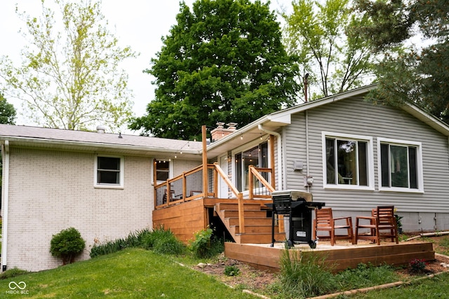 6799 Lakeshore Dr, Avon, IN 46123 - back of property with a wooden deck, a lawn, brick siding, and a chimney