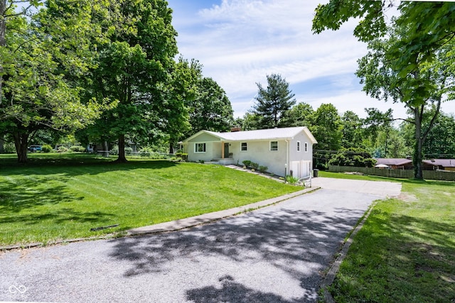 6799 Lakeshore Dr, Avon, IN 46123 - single story home featuring asphalt driveway, a chimney, and stucco siding