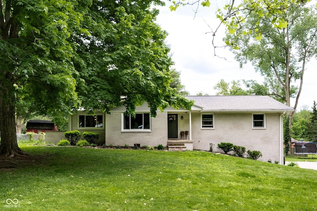 6799 Lakeshore Dr, Avon, IN 46123 - view of front of house with a trampoline, brick siding, and a front lawn