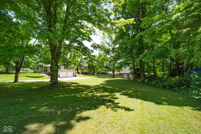 6799 Lakeshore Dr, Avon, IN 46123 - view of green lawn with driveway and a garage