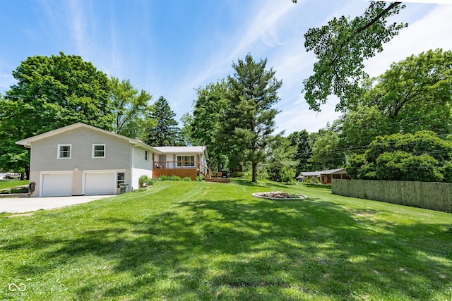 6799 Lakeshore Dr, Avon, IN 46123 - view of yard with a garage, driveway, and view of wooded area
