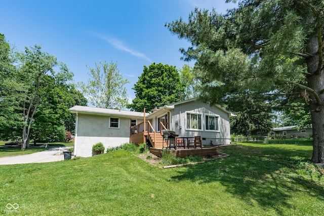 6799 Lakeshore Dr, Avon, IN 46123 - rear view of house featuring brick siding, a lawn, and a deck