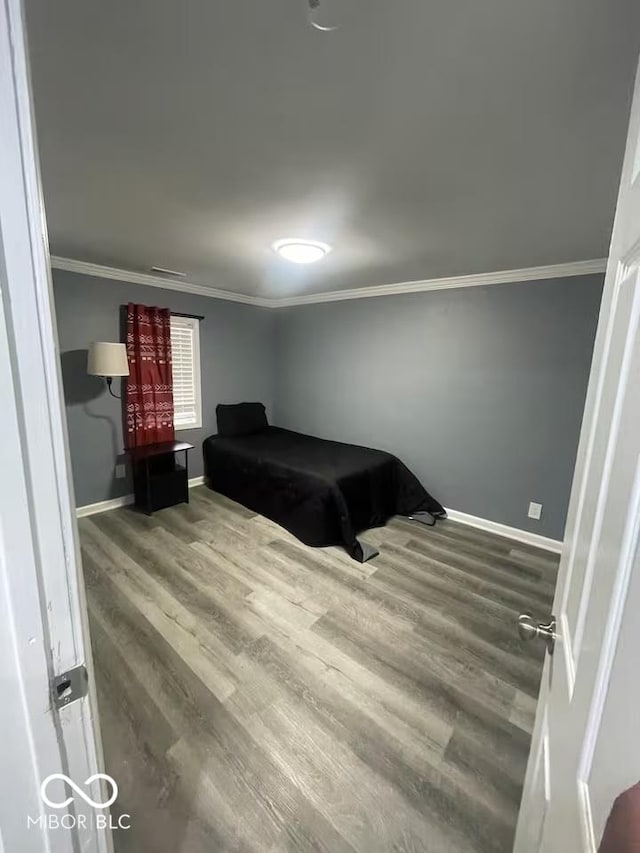 3041 S Rybolt Ave, Indianapolis, IN 46241 - bedroom with wood finished floors, ornamental molding, and baseboards