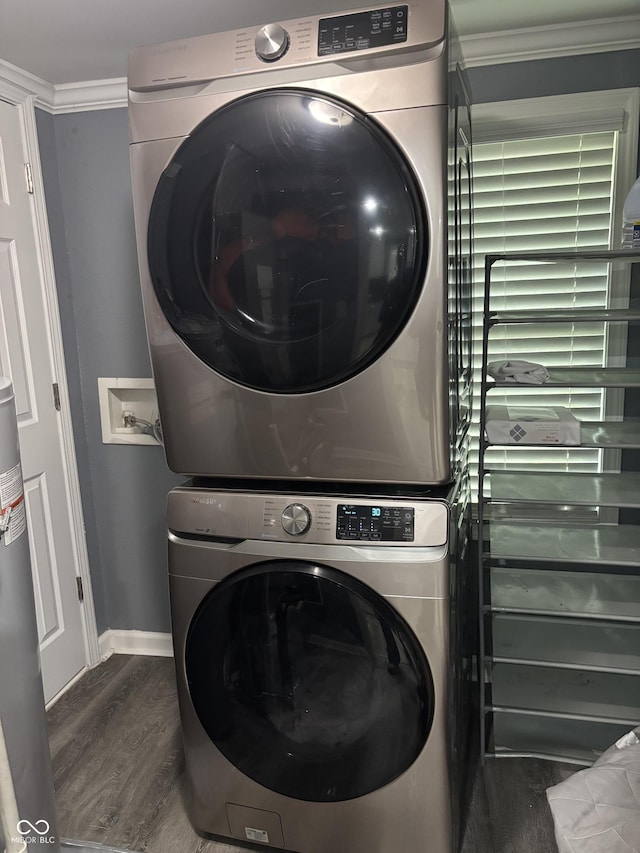 3041 S Rybolt Ave, Indianapolis, IN 46241 - laundry room featuring stacked washer / drying machine, baseboards, crown molding, and dark wood finished floors