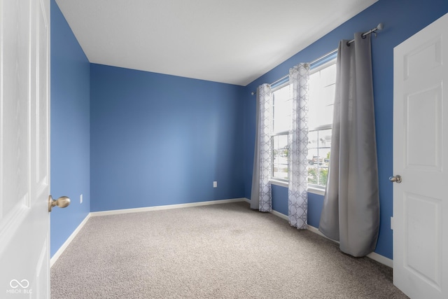 2502 Creekland Dr, Columbus, IN 47201 - spare room featuring carpet flooring and baseboards