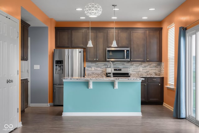 2502 Creekland Dr, Columbus, IN 47201 - kitchen with stainless steel appliances, dark wood-style flooring, backsplash, an island with sink, and recessed lighting
