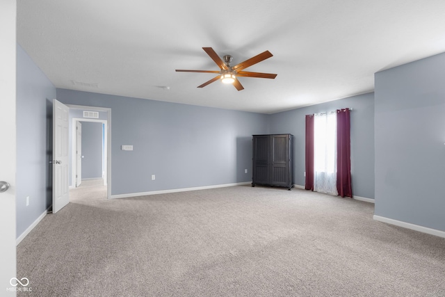 2502 Creekland Dr, Columbus, IN 47201 - empty room with light colored carpet, ceiling fan, and baseboards