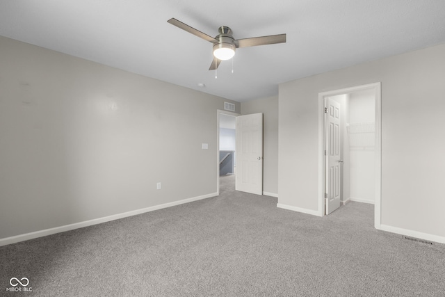 2502 Creekland Dr, Columbus, IN 47201 - unfurnished bedroom with carpet floors, baseboards, a spacious closet, ceiling fan, and a closet