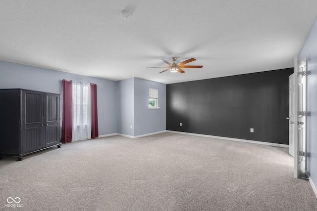 2502 Creekland Dr, Columbus, IN 47201 - spare room featuring a ceiling fan, light carpet, and baseboards