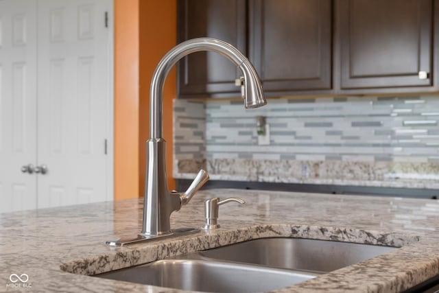 2502 Creekland Dr, Columbus, IN 47201 - kitchen view of a sink, decorative backsplash, and light stone countertops